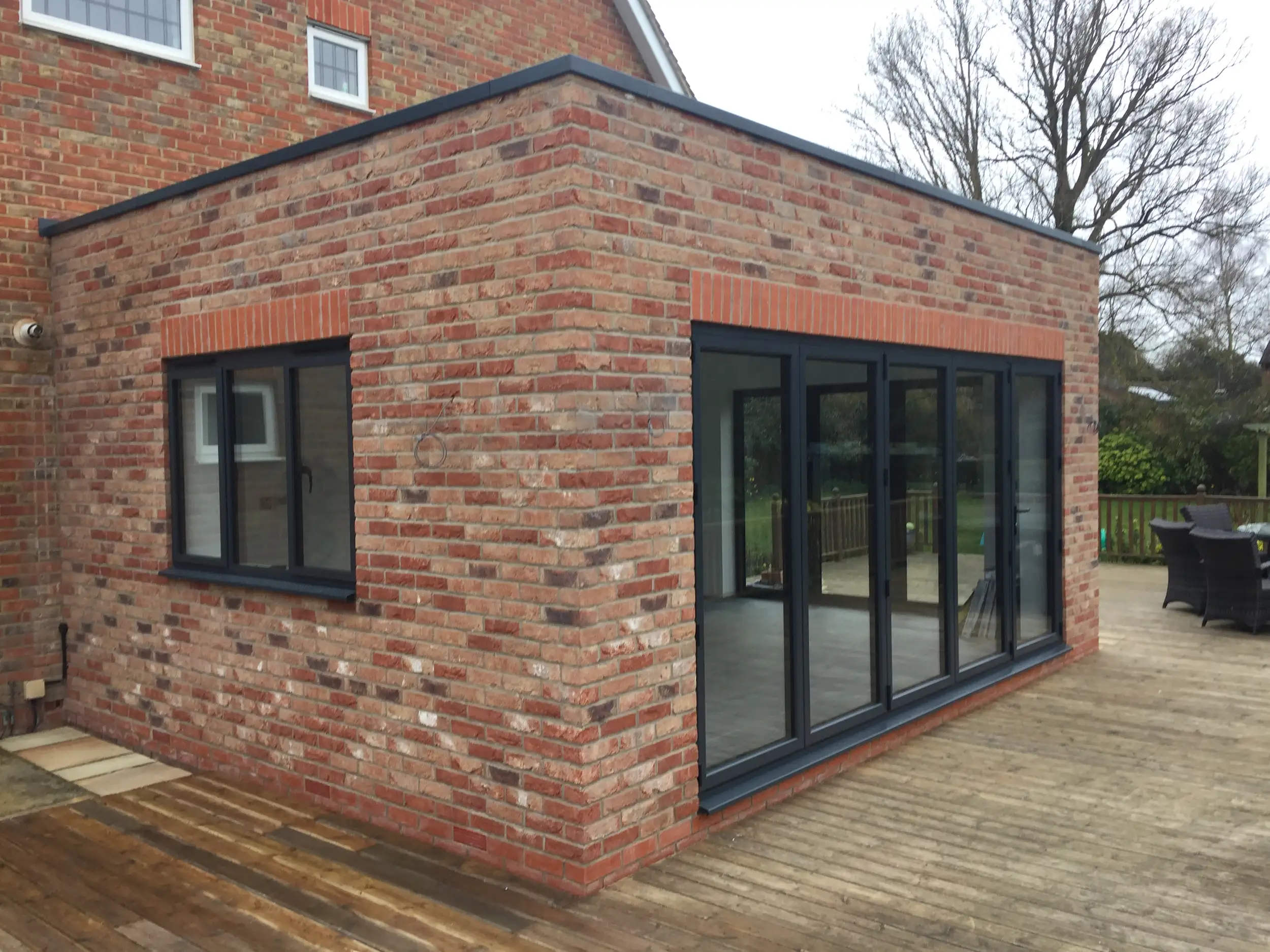 Brick garden room with bi-fold doors and decking